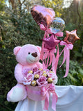Pink Teddy Hugging a Gift Box